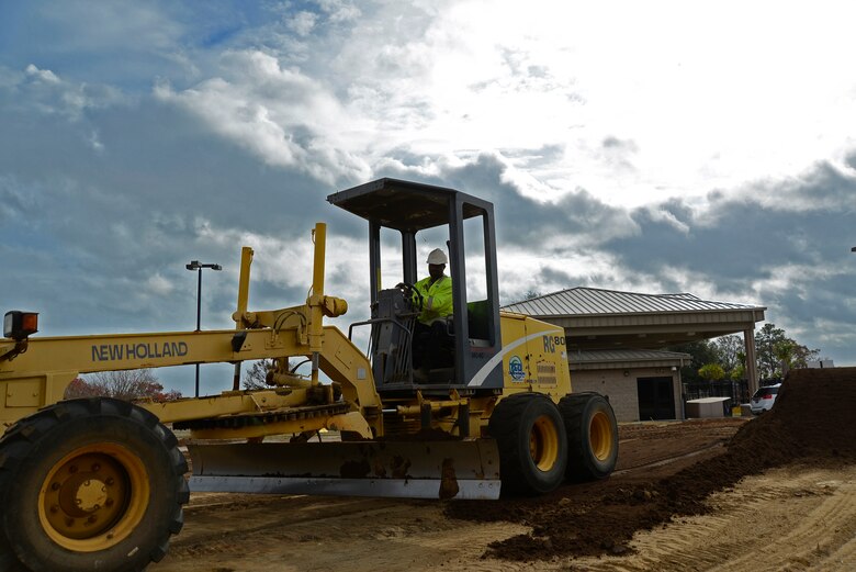 Gene Ham, contracted motor grader operator, evenly distributes dirt at Shaw Air Force Base, S.C., Nov. 29, 2016. Main Gate renovations will ease the outbound traffic flow while making it more difficult for unauthorized vehicles to gain access to the base. (U.S. Air Force photo by Airman 1st Class BrieAnna Stillman)