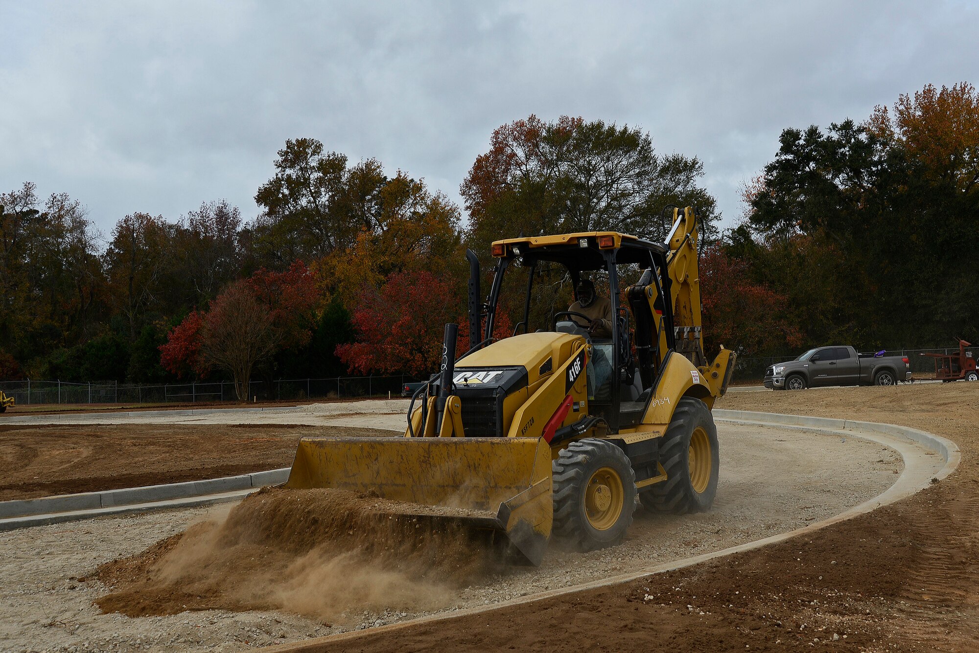 William McElveen, contracted backhoe operator, picks up dirt to move it to a different location at Shaw Air Force Base, S.C., Nov. 29, 2016. When finished, the new outbound lanes at the Main Gate will provide better traffic flow as well as more protection for Team Shaw members. (U.S. Air Froce photo by Airman 1st Class BrieAnna Stillman) 