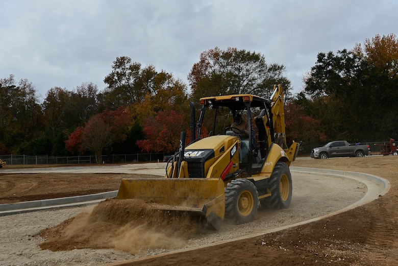 William McElveen, contracted backhoe operator, picks up dirt to move it to a different location at Shaw Air Force Base, S.C., Nov. 29, 2016. When finished, the new outbound lanes at the Main Gate will provide better traffic flow as well as more protection for Team Shaw members. (U.S. Air Froce photo by Airman 1st Class BrieAnna Stillman) 