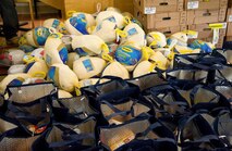 Frozen turkeys and thermal grocery bags filled with food items sit ready for distribution to pre-selected Team Dover military families Nov. 18, 2016, at the Landings on Dover Air Force Base, Del. The Dover First Sergeant Council, additional duty first sergeants, wing leadership, donators and volunteers put together 211 Thanksgiving holiday food baskets that were distributed to Airmen assigned to 17 squadrons on base. (U.S. Air Force photo by Roland Balik)