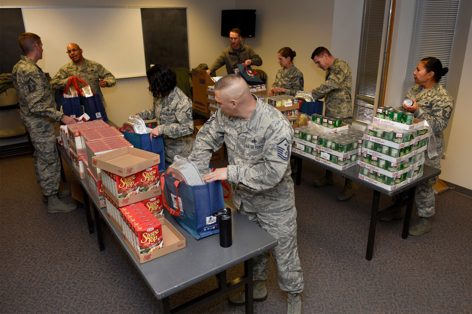 PETERSON AIR FORCE BASE, Colo. – Peterson first sergeants put together bags of Thanksgiving food items at the base chapel on Peterson Air Force Base, Colo., Nov. 21, 2016. Thanksgiving baskets were put together for Airmen and their families who needed assistance during the holidays. (U.S. Air Force photo by Senior Airman Rose Gudex)