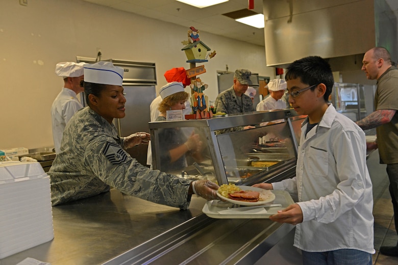 U.S. Air Force Senior Master Sgt. Tameka Taylor, 20th Contracting Squadron superintendent, serves food to a Team Shaw member at the Chief Master Sgt. Emerson E. Williams Dining Facility at Shaw Air Force Base, S.C., Nov. 24, 2016. As part of a holiday season tradition, commanders, chiefs and first sergeants volunteered their time to help the dining facility staff serve food to the Team Shaw community. (U.S. Air Force photo by Airman 1st Class Destinee Sweeney)