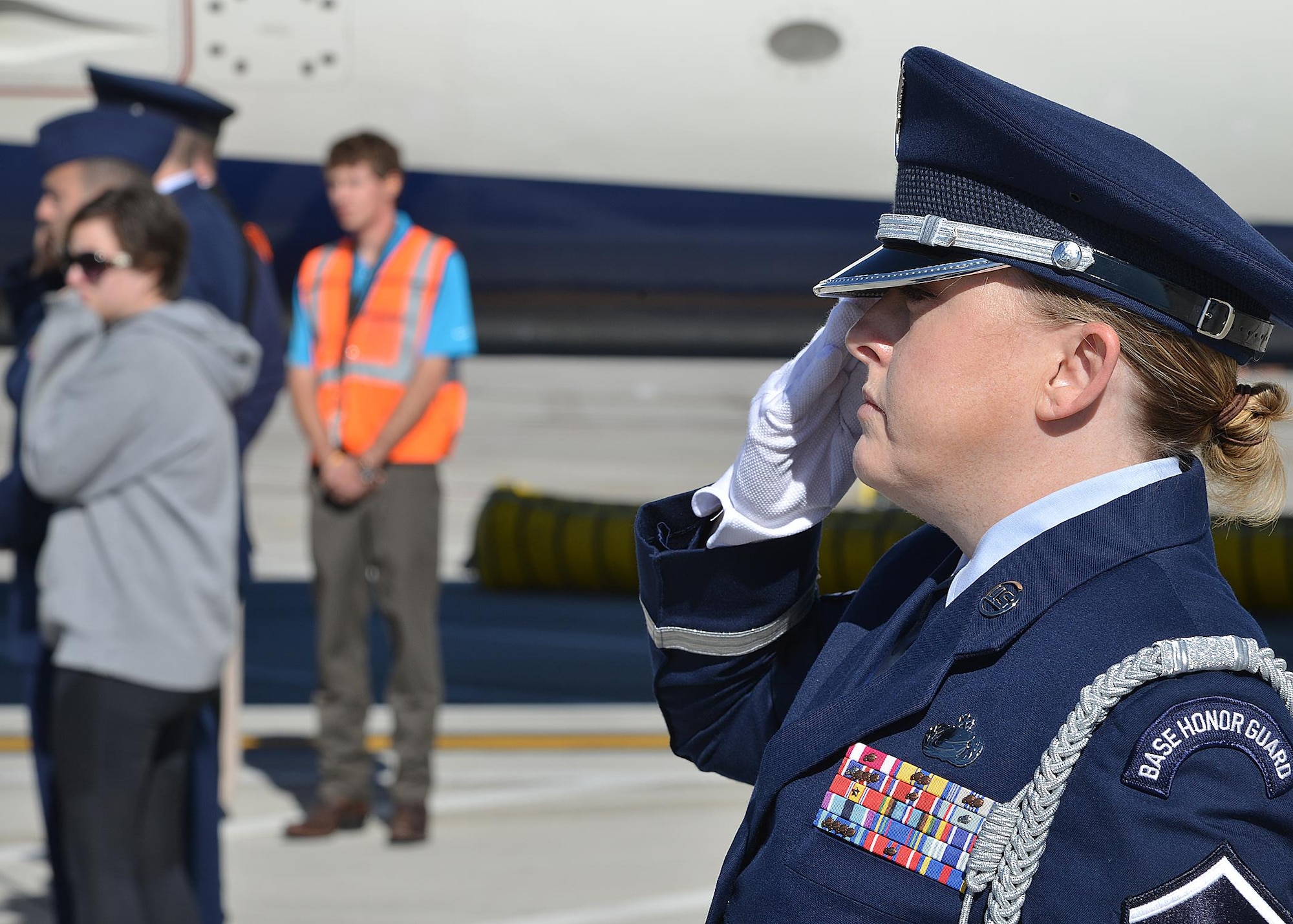 Kirtland Air Force Base Honor Guard members act as pallbearers for Tech. Sgt. Nicholas Heck on Nov. 18 as his remains arrive at the Albuquerque International Sunport en route to Cannon Air Force Base for the funeral. This dignified arrival, the primary mission of honor guards, was the first
KAFB Honor Guard has performed in many years. Six Honor Guard members act as pallbearers and a seventh renders a salute. Heck was stationed at Cannon before transferring to Yakota Air Base, Japan, where he died.