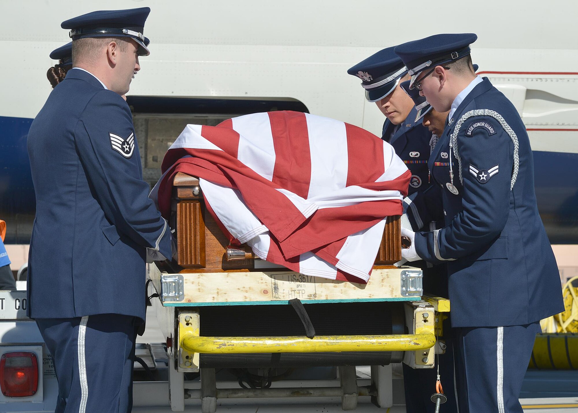 Kirtland Air Force Base Honor Guard members act as pallbearers for Tech. Sgt. Nicholas Heck on Nov. 18 as his remains arrive at the Albuquerque International Sunport en route to Cannon Air Force Base for the funeral. This dignified arrival, the primary mission of honor guards, was the first
KAFB Honor Guard has performed in many years. Six Honor Guard members act as pallbearers and a seventh renders a salute. Heck was stationed at Cannon before transferring to Yakota Air Base, Japan, where he died.