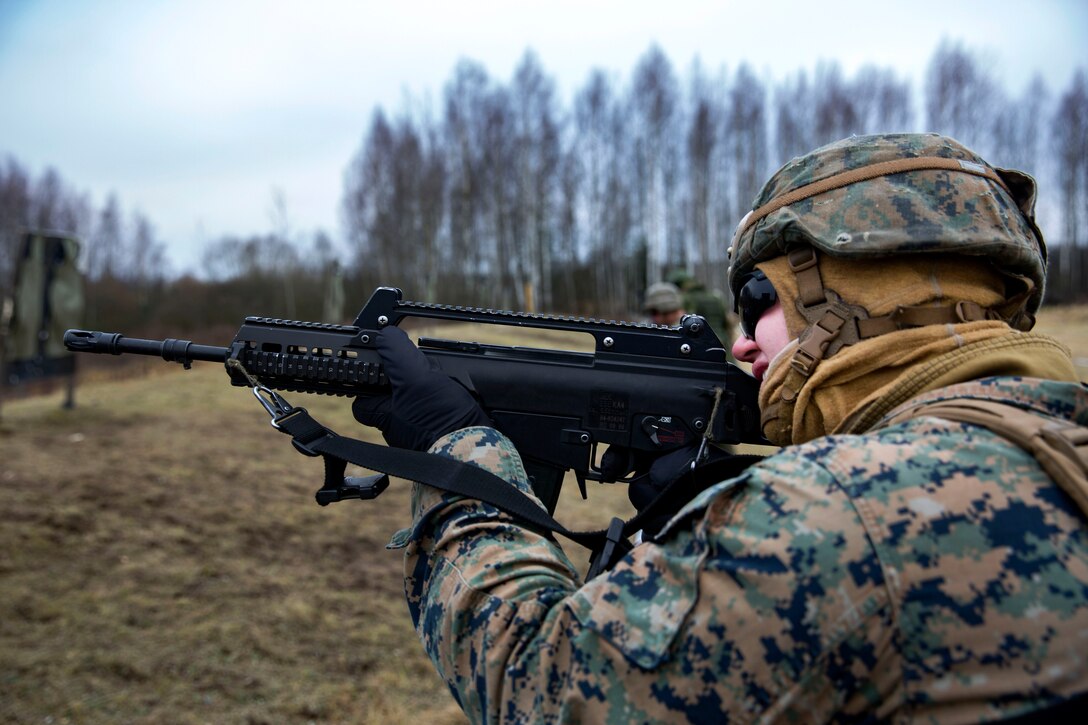 A Marine engages his target with a G36 rifle during a live-fire range, part of Exercise Iron Sword 2016 in the Rukla Training Area, Rukla, Lithuania, Nov. 23, 2016. Marine Corps photo by Cpl. Clarence L. Wimberly