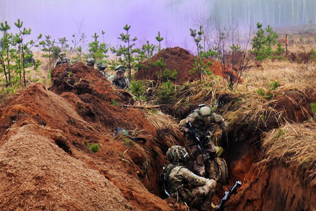 Paratroopers assault a trench during Exercise Iron Sword 2016 in Pabrade, Lithuania, Nov. 24, 2016. Army photo by Staff Sgt. Corinna Baltos