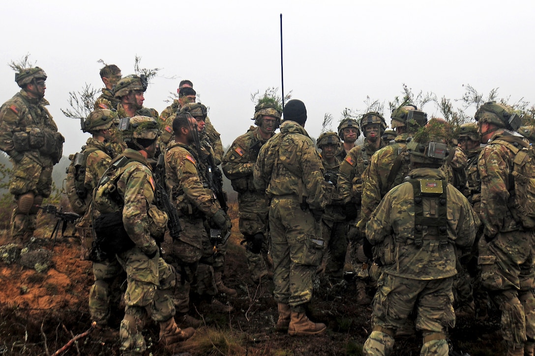 Army 1st Sgt. Roberto Ayala, center, conducts an after-action review with his paratroopers following a trench assault during Exercise Iron Sword 2016 in Pabrade, Lithuania, Nov. 24, 2016. Ayala is assigned to Company A, 2nd Battalion, 503rd Infantry Regiment, 173rd Infantry Brigade Combat (Airborne). Army photo by Staff Sgt. Corinna Baltos