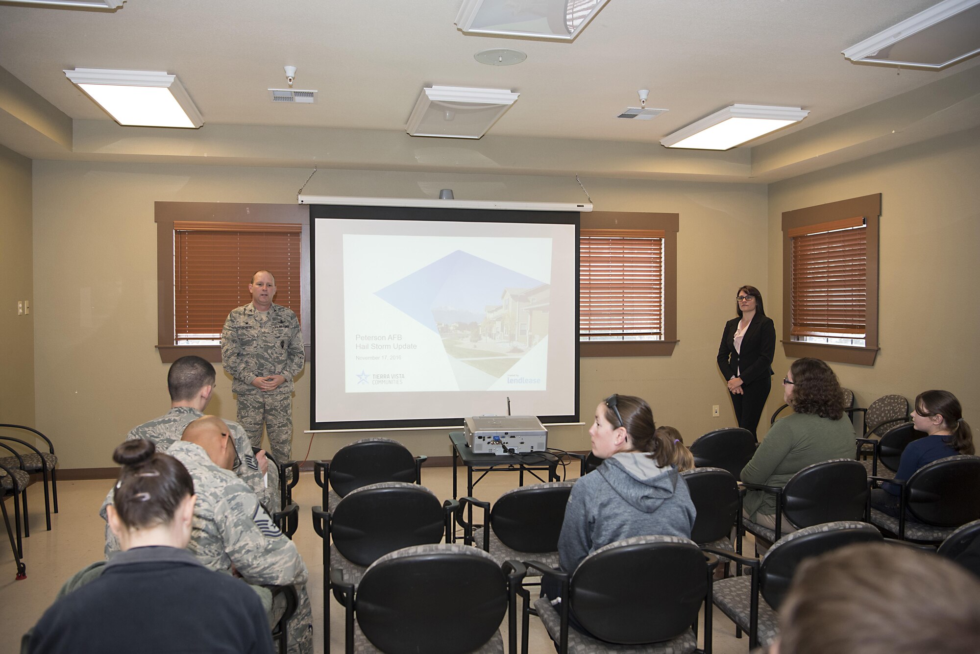 Col. Doug Schiess, 21st Space Wing commander, and Iris KirkPilger, a representative from Tierra Vista Community, speaks to housing residents during a town hall meeting at Peterson Air Force Base, Colo., Nov. 18, 2016. The town hall informed residents of Tierra Vista Community about the repair plans for homes damaged during the hail storm that occurred here on July 28. (U.S. Air Force photo by Steve Kotecki)