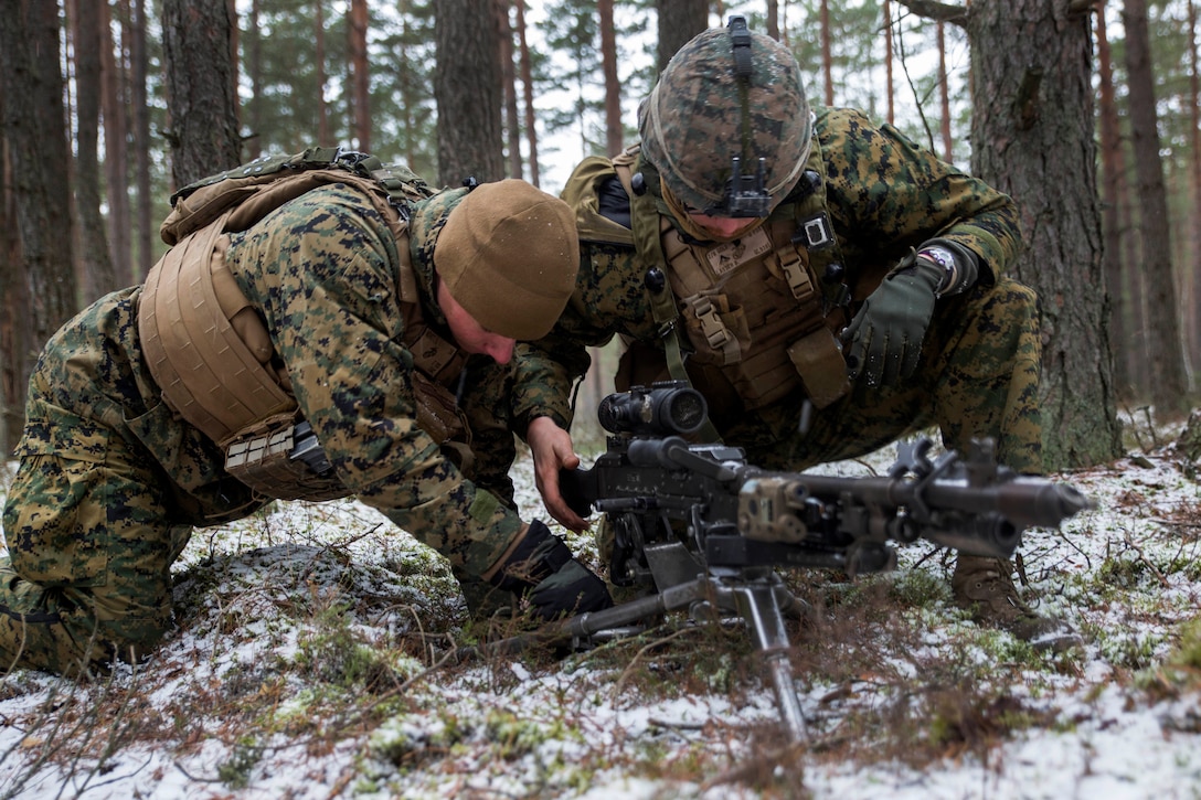 Marines make adjustments to a machine gun while participating in a training mission during Exercise Iron Sword 16 at Rukla Training Area, Rukla, Lithuania, Nov. 28, 2016. Marine Corps photo by Sgt. Kirstin Merrimarahajara