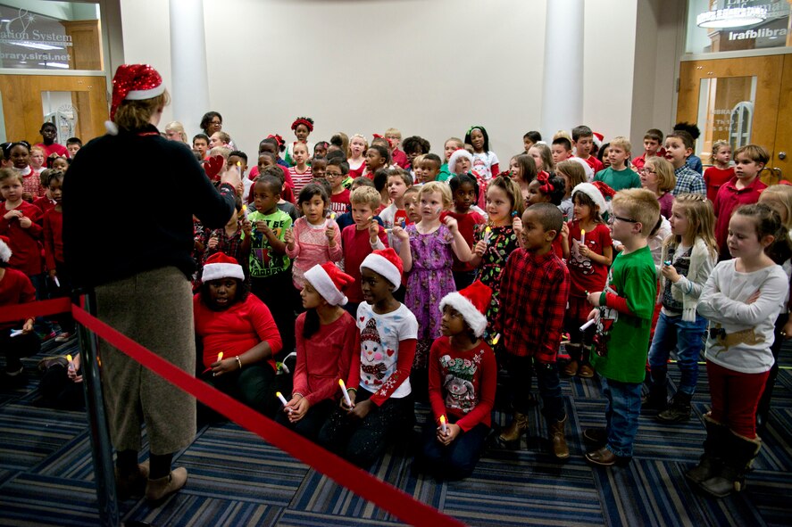 Music Teacher Lori Dulaney, directs the Arnold Elementary School Choir during the Base Tree Lighting & Winter Wonderland in the Walters Community Center, Nov. 29, 2016, at Little Rock Air Force Base, Ark. Hundreds of people gathered for the annual event that included crafts, children’s activities, storytelling by Mrs. Claus and pictures with Santa. (U.S. Air Force photo by Master Sgt. Jeff Walston/Released)     