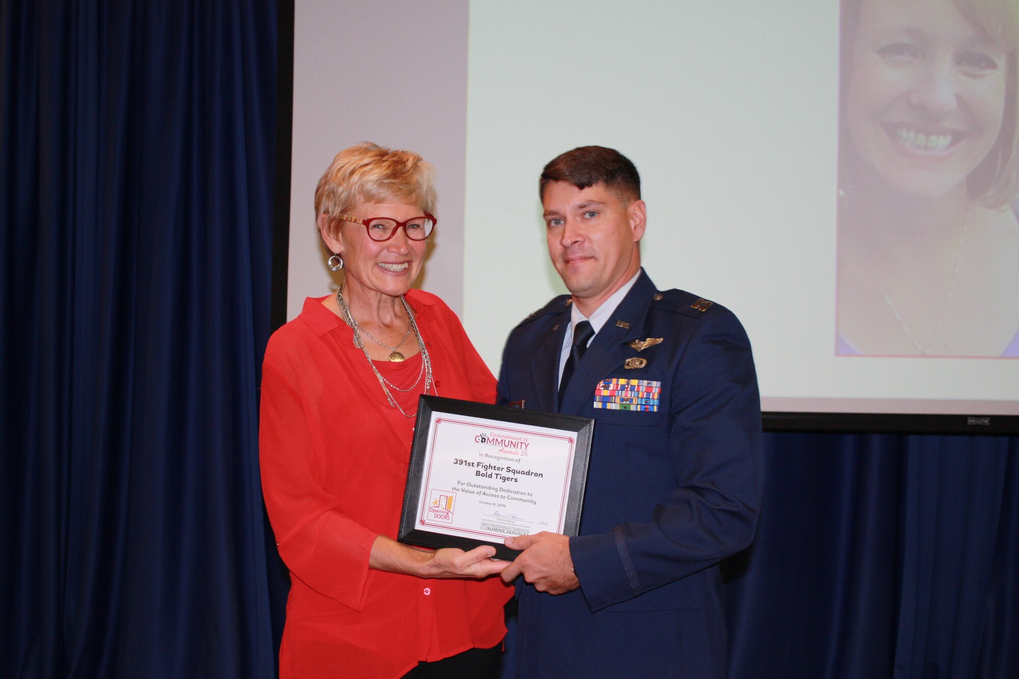 Capt. Adam Huffman, 366th Operation Squadron executive officer, receives a certificate from Katherine Hansen, Community Parthnerships of Idaho executive director, during a lucheon ceremony at Boise State University, in Boise, Idaho, Oct. 6, 2016. The 391st Fighter Squadron was nominated for the Opening Doors Award for its dedication to helping individuals with disabilities. More than 540 attendees recognized the achievements of this year's 17 nominees. (Courtesy Photo)