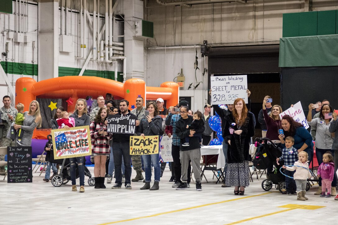 More than 160 friends, family members and coworkers wait to greet about 80 Airmen returning from a deployment supporting OPERATION INHERENT RESOLVE, Nov. 23, 2016, at Seymour Johnson Air Force Base, North Carolina. The Airmen worked 24/7 to conduct operations that directly aided in the Department of Defense’s efforts to destroy and degrade the Islamic State of Iraq and Levant. (U.S. Air Force photo by Airman Shawna L. Keyes)