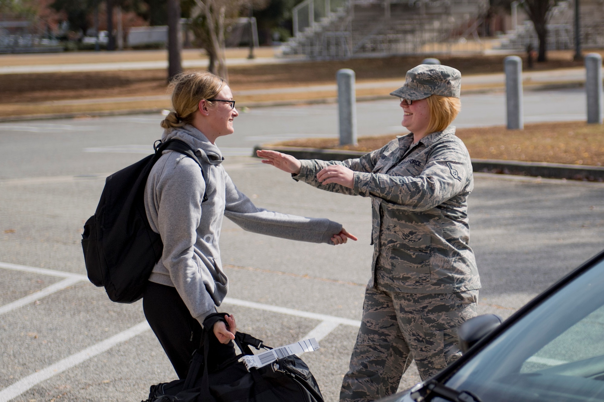 Airman Elizabeth Davis, right, 23d Communications Squadron knowledge management technician, reaches to embrace her sister, Airman 1st Class Ashley Moody, 23d CS client systems technician, Nov. 30, 2016, at Moody Air Force Base, Ga. This was the first time the sisters have seen each other since February, and only the fifth time in eight years. (U.S. Air Force photo by Airman 1st Class Daniel Snider)