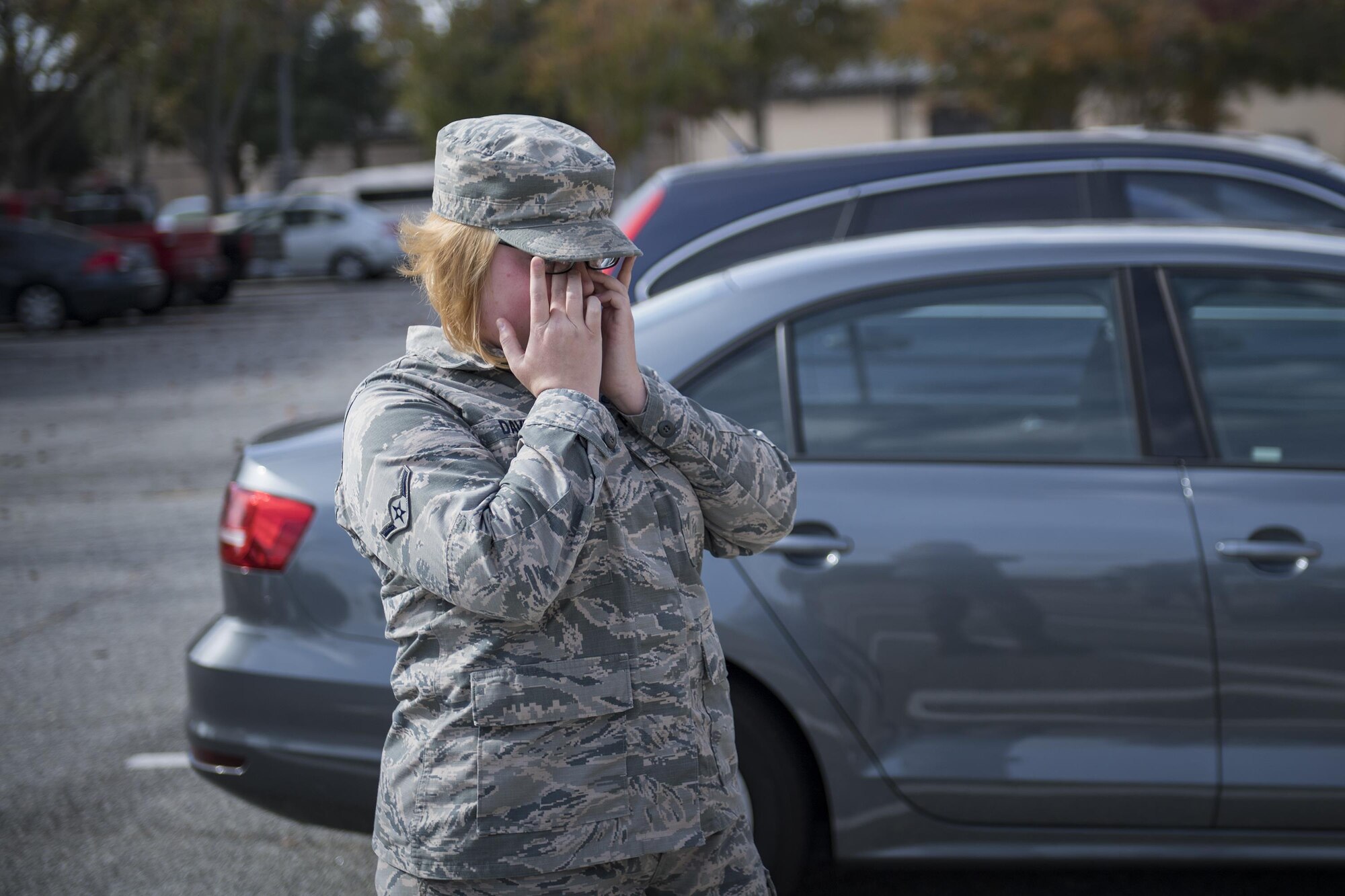 Airman Elizabeth Davis, 23d Communications Squadron knowledge management technician, wipes tears away from her eyes after greeting her sister, Nov. 30, 2016, at Moody Air Force Base, Ga. The sisters are stationed at Moody and both work in the 23d CS. Davis influenced her sister’s decision to pursue working in a communications squadron. (U.S. Air Force photo by Airman 1st Class Daniel Snider)