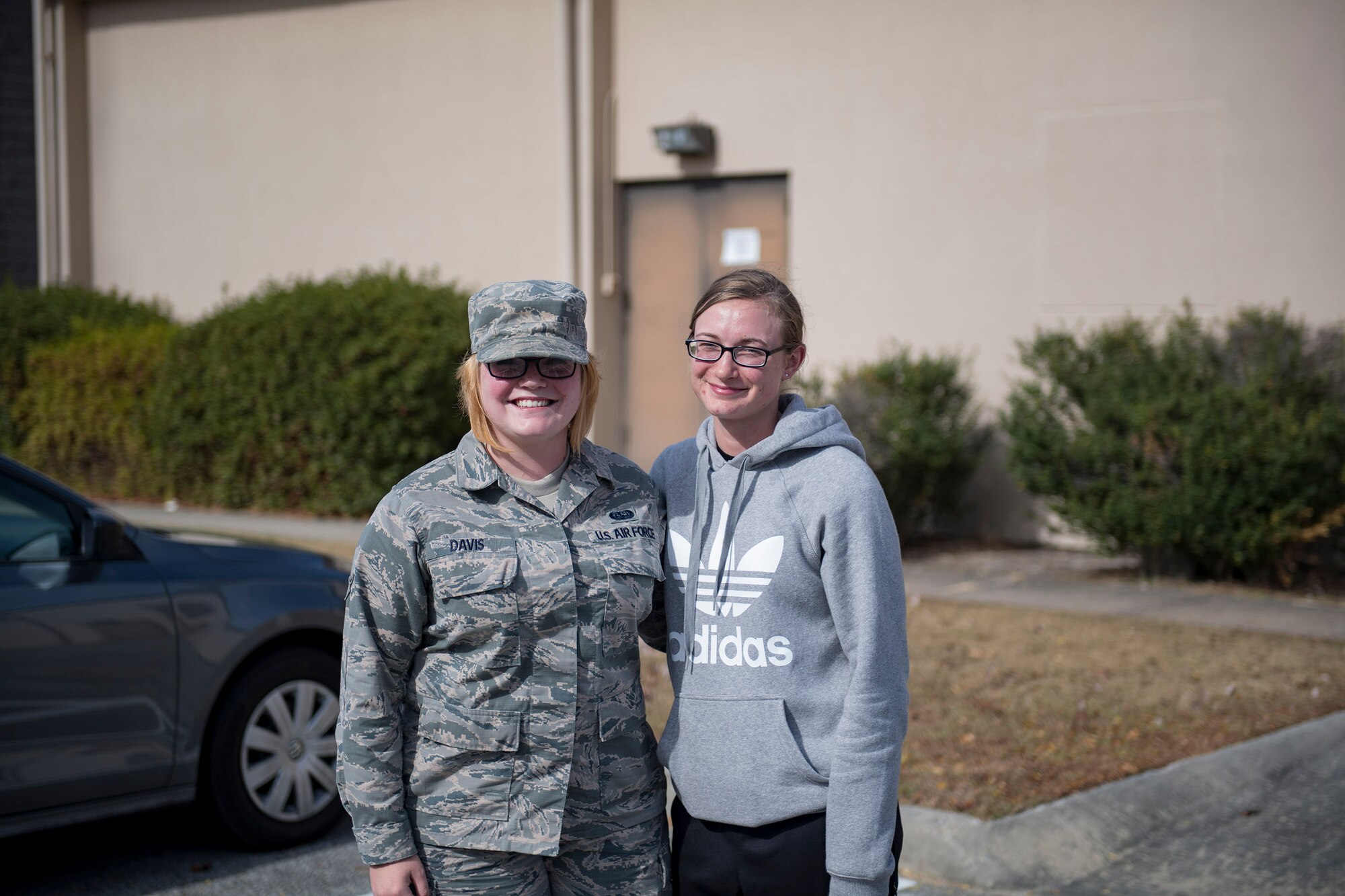 Airman Elizabeth Davis, left, 23d Communications Squadron knowledge management technician, and Airman 1st Class Ashley Moody, 23d CS client systems technician, pose for a photo, Nov. 30, 2016, at Moody Air Force Base, Ga. Davis joined the Air Force in February of 2015, with Moody’s reaction being that she’d never join the military. However, in May of 2016 after seeing Davis’s success, Moody followed her sister’s path and enlisted. (U.S. Air Force photo by Airman 1st Class Daniel Snider)