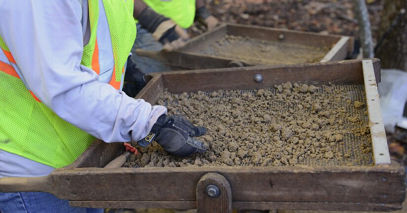 Contractors sift through dirt samples during an excavation at Joint Base Langley-Eustis, Va., Nov. 4, 2016. There are 234 archeological sites on JBLE, and these excavations will provide more information on the historical significance of three new sites. (U.S. Air Force photo by Staff Sgt. Teresa J. Cleveland)