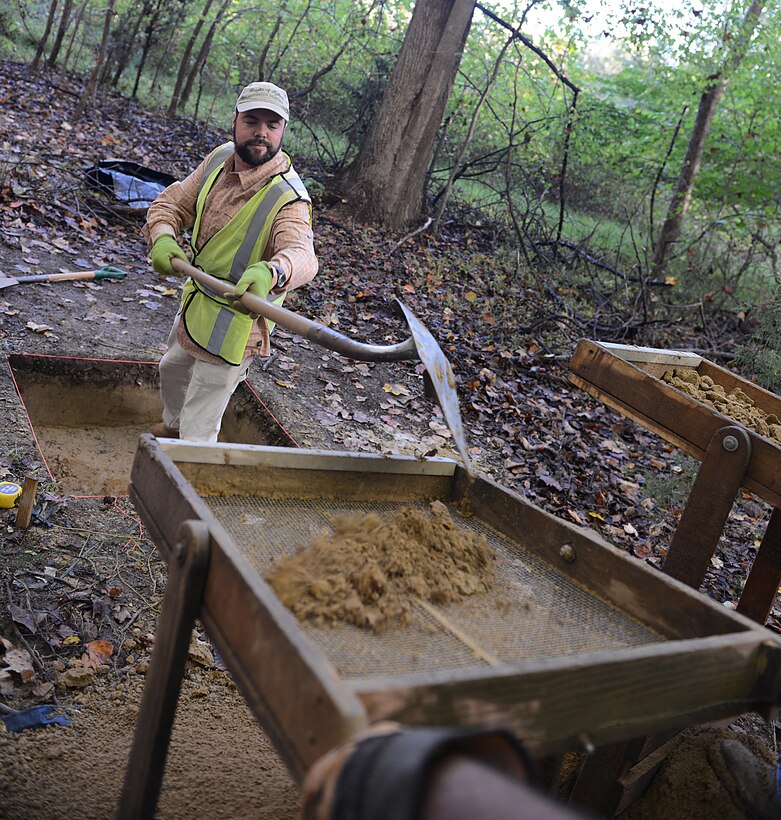 A contractor shovels dirt samples into sifters during excavations at Joint Base Langley-Eustis, Va., Nov. 4, 2016. Sifting the dirt allows members to search for artifacts and any significant change in the soil patterns that may provide more information on the history of people who lived in the area. (U.S. Air Force photo by Staff Sgt. Teresa J. Cleveland)