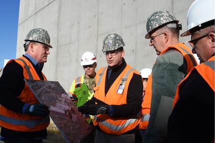U.S. Air Force Gen. John E. Hyten (second from right), U.S. Strategic Command (USSTRATCOM) commander, receives a briefing from Mr. Michael Kolster (second from left), USSTRATCOM Program Management Office (PMO) military construction chief, and Mr. James Weber (left), USSTRATCOM PMO operations and strategic communications action officer, during his tour of USSTRATCOM’s Command and Control Facility (C2F), Nov. 28, 2016 at Offutt Air Force Base, Neb. The USSTRATCOM C2F is designed to meet current mission requirements with the flexibility to expand for future mission needs.  The command is scheduled to begin moving near the end of 2018 with full operational capability by Spring of 2019. One of nine DoD unified combatant commands, USSTRATCOM has global strategic missions, assigned through the Unified Command Plan, which include strategic deterrence; space operations; cyberspace operations; joint electronic warfare; global strike; missile defense; intelligence, surveillance and reconnaissance; combating weapons of mass destruction; and analysis and targeting.  (USSTRATCOM photo by Master Sgt. April Wickes)