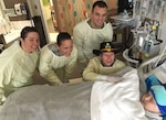 Washington National Guard members visit with Rowan Windham, right, an honorary member of the Texas National Guard, at Seattle Children's Hospital in Seattle, Washington, Oct. 28, 2016. Texas Command Senior Enlisted Leader Command Sgt. Maj. Mark Weedon asked the Washington National Guard to visit Rowan on behalf of Texas. 