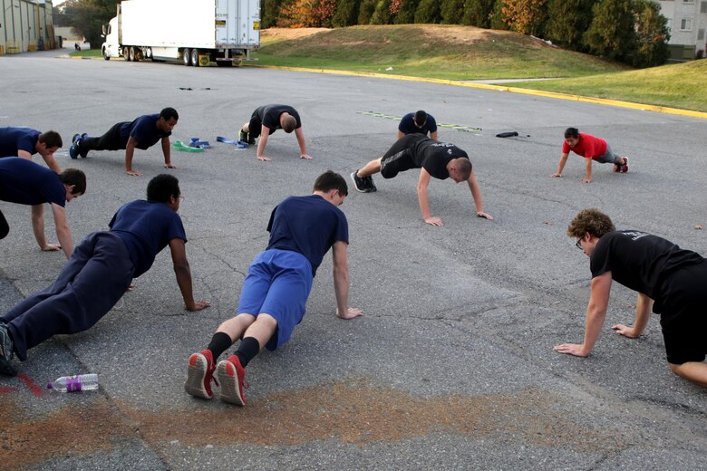 Future Marine Recruits with Marine Corps Recruiting Sub-Station Glen Burnie, Marine Corps Recruiting Station Baltimore, Marine Corps Recruiting Command, conduct a dynamic warm-up before doing a physical training session in Glen Burnie, Maryland, November 15, 2016. Young men and women awaiting boot camp conduct physical training sessions with their Marine Corps recruiters before going to boot camp at Marine Corps Recruit Depot Parris Island, South Carolina. (U.S. Marine Corps photo by Sgt. Devin Nichols/Released)