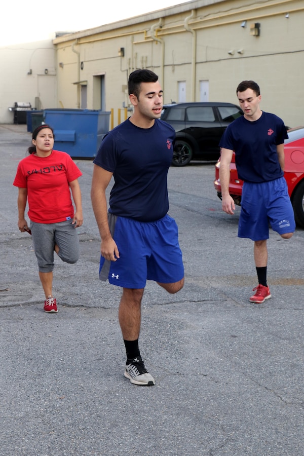 Demetri E. Ramos, center, leads Future Marine Recruits with Marine Corps Recruiting Sub-Station Glen Burnie, Marine Corps Recruiting Station Baltimore, Marine Corps Recruiting Command, in a dynamic warm-up before doing a physical training session in Glen Burnie, Maryland, November 15, 2016. Young men and women awaiting boot camp conduct physical training sessions with their Marine Corps recruiters before going to boot camp at Marine Corps Recruit Depot Parris Island, South Carolina. (U.S. Marine Corps photo by Sgt. Devin Nichols/Released)
