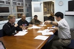 Takaatsu Sueyoshi, right, instructs students on Japanese pronunciation during a Survival Japanese Language Class Nov. 29 on Marine Corps Air Station Futenma, Okinawa, Japan. The class taught students basic speech, reading and writing skills to enrich their experience while stationed on Okinawa. During the class, the instructor demonstrated the three basic writing styles called hiragana, katakana and kanji. After the demonstration, participants practiced reading, writing and speaking basic Japanese words and phrases. Sueyoshi is a library technician and the instructor of the Survival Japanese Language class.