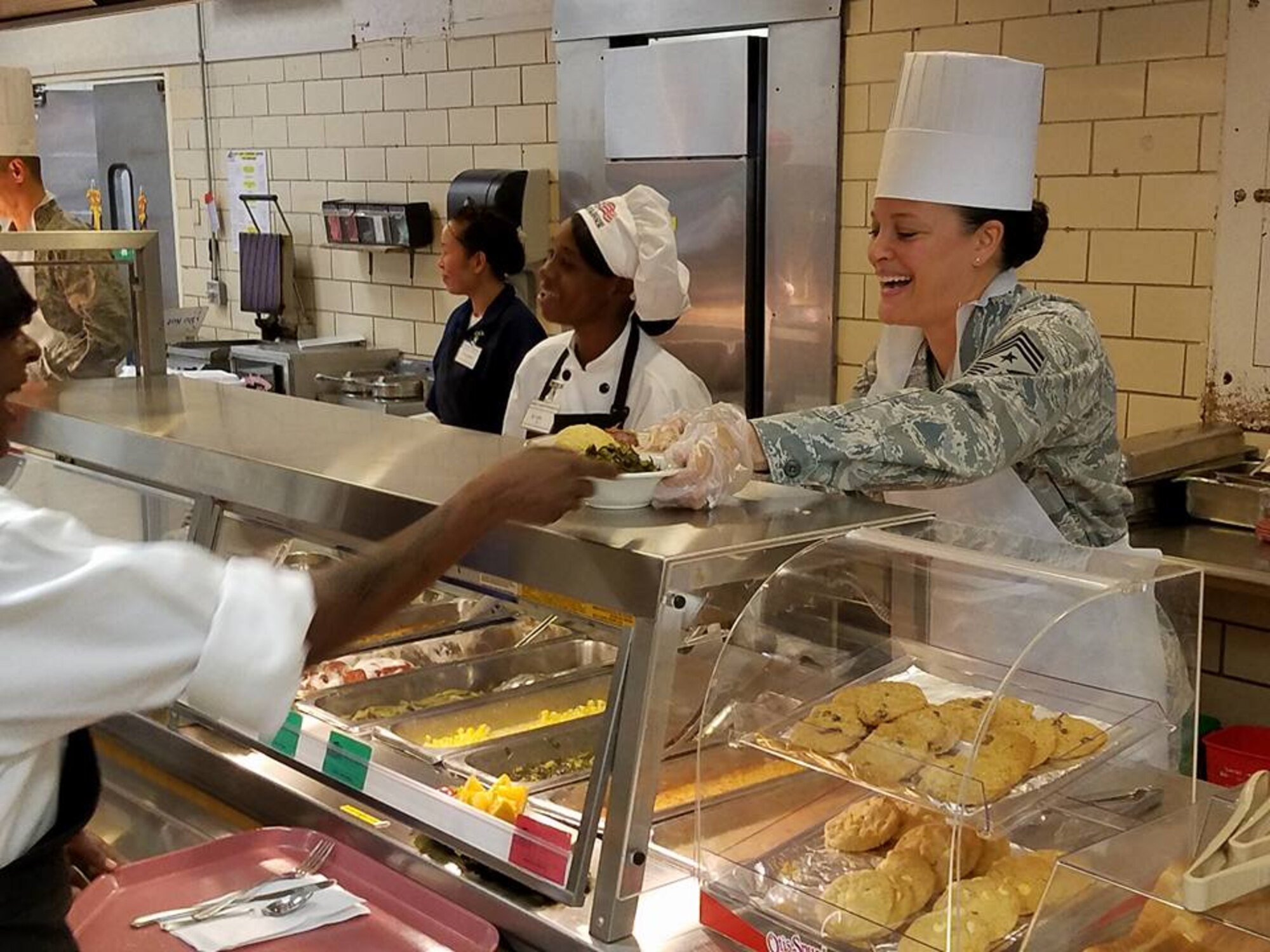 Chief Master Sergeant Laura A. Callaway, 42nd Air Base Wing Command Chief, serves a Thanksgiving meal at the dining facility on Maxwell Air Force Base, Nov. 24, 2016. Base leadership spent time serving all who came to join in the festivities. (Courtesy photo)