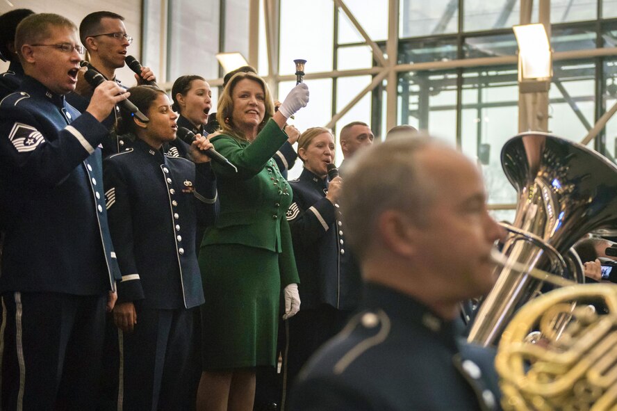 Secretary of the Air Force Deborah Lee James participates in a flash mob at the Smithsonian National Air and Space Museum in Washington D.C., with members of the U.S. Air Force Band, with help from their sister unit the U.S. Air Force Honor Guard, in order to kick off the holiday season by surprising visitors at the Smithsonian's National Air and Space Museum with a flash mob experience Nov. 29, 2016  (U.S. Air Force photo by Senior Master Sgt. Adrian Cadiz)(Released)