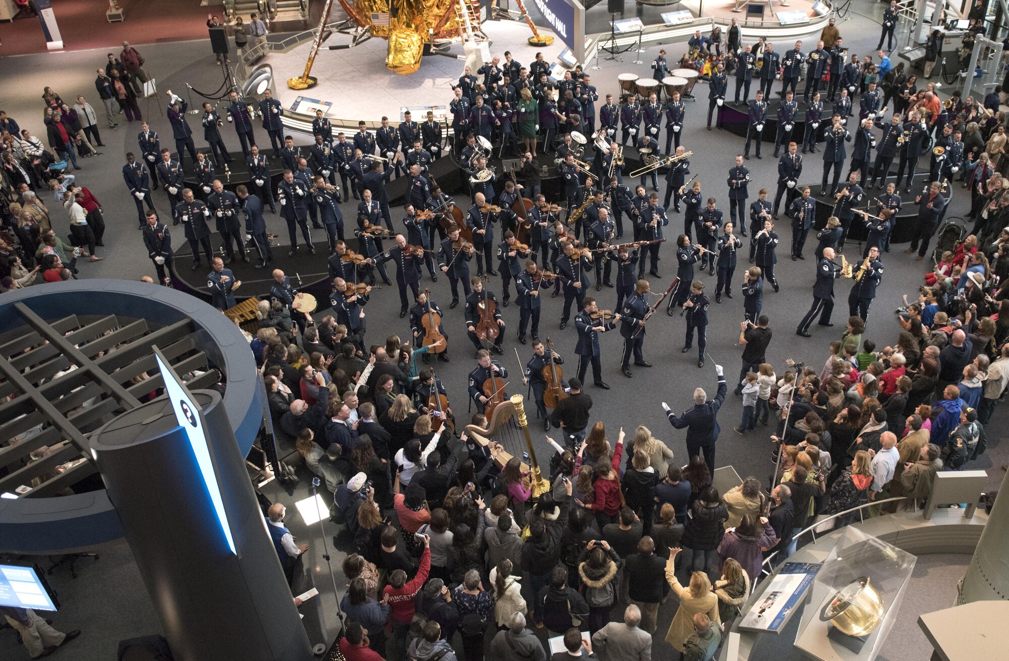 U.S. Air Force Band Commander Col. Larry H. Lang conducts the band's annual holiday flash mob performance at the Smithsonian National Air and Space Museum in Washington, D.C., Nov. 29, 2016. (U.S. Air Force by Airman Gabrielle Spalding)(released)
