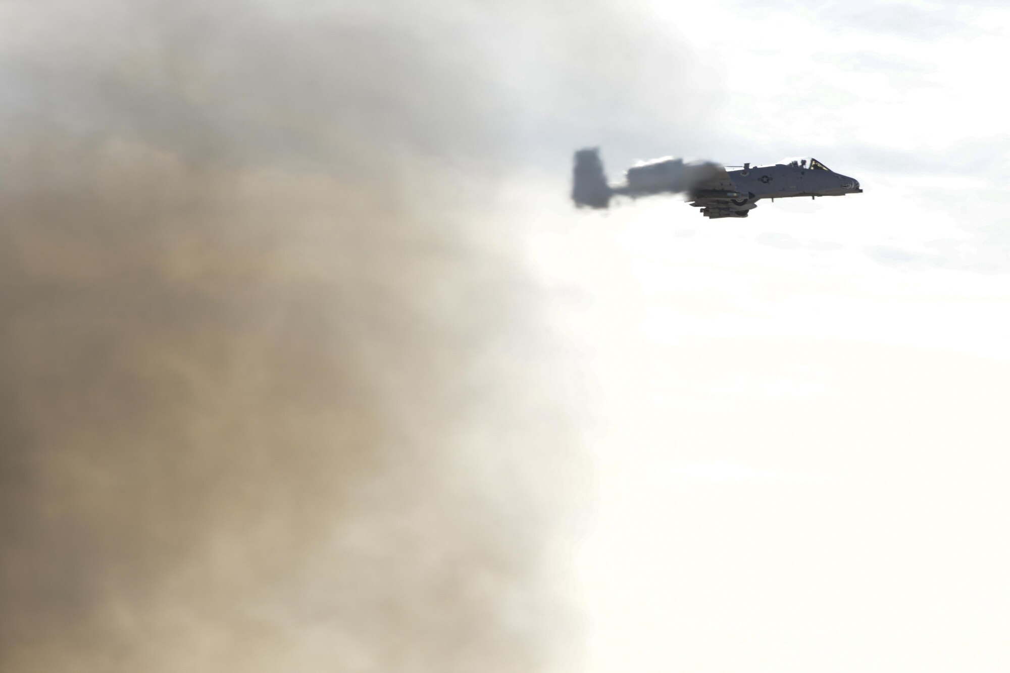 An A-10C Thunderbolt II flies past a fire after completing operational testing at Davis-Monthan Air Force base, Ariz., Nov. 28, 2016.  The Air National Guard Air Force Reserve Command Test Center, A-10 Combined Test Force performed the testing to collect A-10 sensor performance data in the presence of a large fire. (U.S. Air Force photo by Senior Airman Betty R. Chevalier)