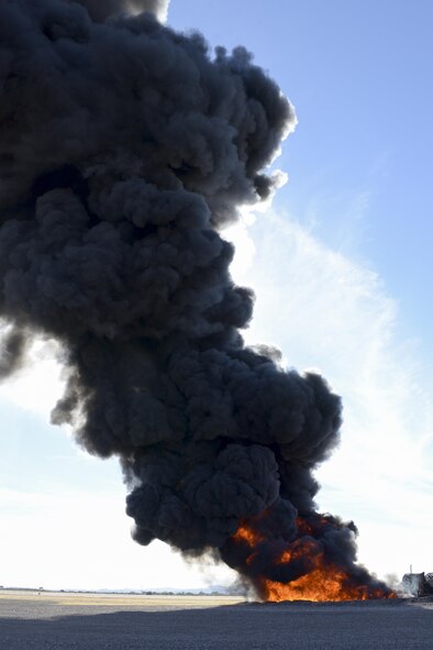 A large fire produces black smoke on the fire training grounds at Davis-Monthan Air Force Base, Ariz., Nov. 28, 2016. The D-M Fire Department allowed the fire to burn longer to simulate conditions pilots may encounter during combat operations, which allowed the Air National Guard Air Force Reserve Command Test Center, A-10 Combined Test Force to conduct operational testing. (U.S. Air Force photo by Senior Airman Betty R. Chevalier)