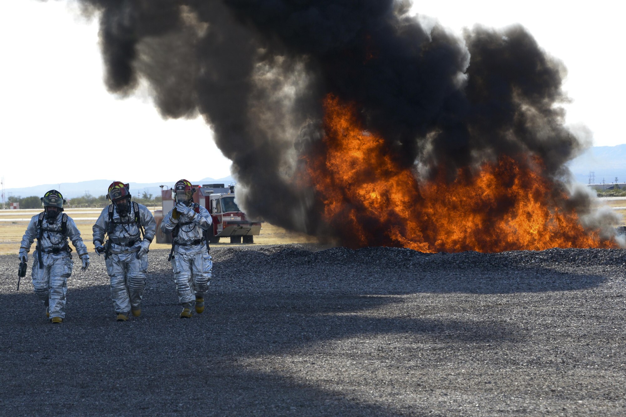 Members of the 355th Civil Engineer Squadron’s fire department walk away from a fire on the fire training grounds at Davis-Monthan Air Force Base, Ariz., Nov. 28, 2016.  The fire department used recycled JP-8 jet fuel to conduct fire training as well as support the Air National Guard Air Force Reserve Command Test Center, A-10 Combined Test Force with operational testing. (U.S. Air Force photo by Senior Airman Betty R. Chevalier)