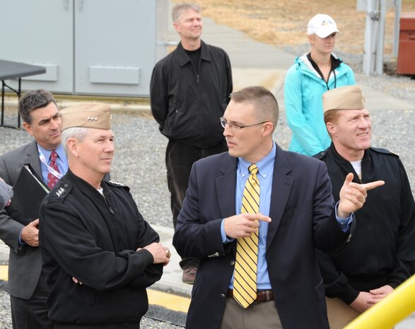 Ben McGlasson, Naval Surface Warfare Center Dahlgren Division (NSWCDD) electromagnetic railgun technical director, briefs Vice Adm. Thomas Moore, commander of the Naval Sea Systems Command, on the electromagnetic railgun autoloader during Moore's visit to NSWCDD, Nov. 30. 