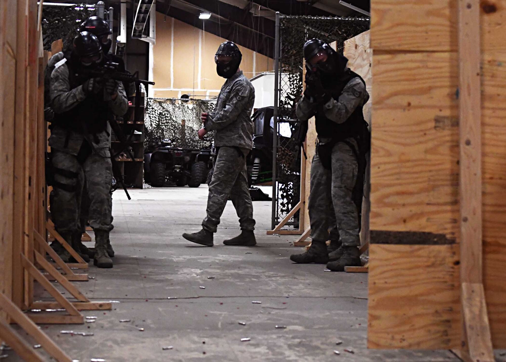 Staff Sgt. Cody Crunelle, center, 319th Security Forces Squadron trainer, watches as other members of the 319th SFS go through a training scenario Nov. 29, 2016, on Grand Forks Air Force Base, N.D. Crunelle and the rest of the 319th SFS training team are responsible for evaluating Airmen on their ability to use proper techniques in a variety of situations. (U.S. Air Force photo by Senior Airman Ryan Sparks)