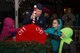 Col. Roman L. Hund, installation commander, flips the light switch from off to on during the annual Christmas Tree Lighting Ceremony with help from Anaily Garcia, left, Alexandria Kircher, center, and Hunter Kircher, right, outside the base chapel Nov. 30. Before the tree lighting, the Bedford High School A’Capella Ensemble and Hanscom Middle School band performed holiday music as children waited for the arrival of Santa Claus. (U.S. Air Force photo by Mark Herlihy)