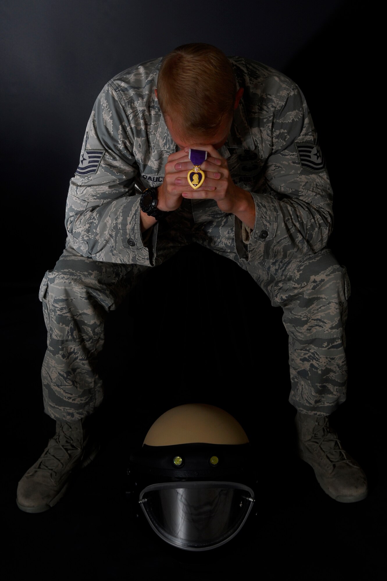 Tech. Sgt. Steven Dauck, 56th Civil Engineer Squadron explosive ordinance disposal team leader, holds the Purple Heart Medal Nov. 30, 2016, at Luke Air Force Base, Ariz. Dauck received his Purple Heart for his actions during a route clearance patrol where he was hit by an improvised explosive device in Afghanistan, Oct. 28, 2011. (U.S. Air Force photo by Airman 1st Class Alexander Cook)  