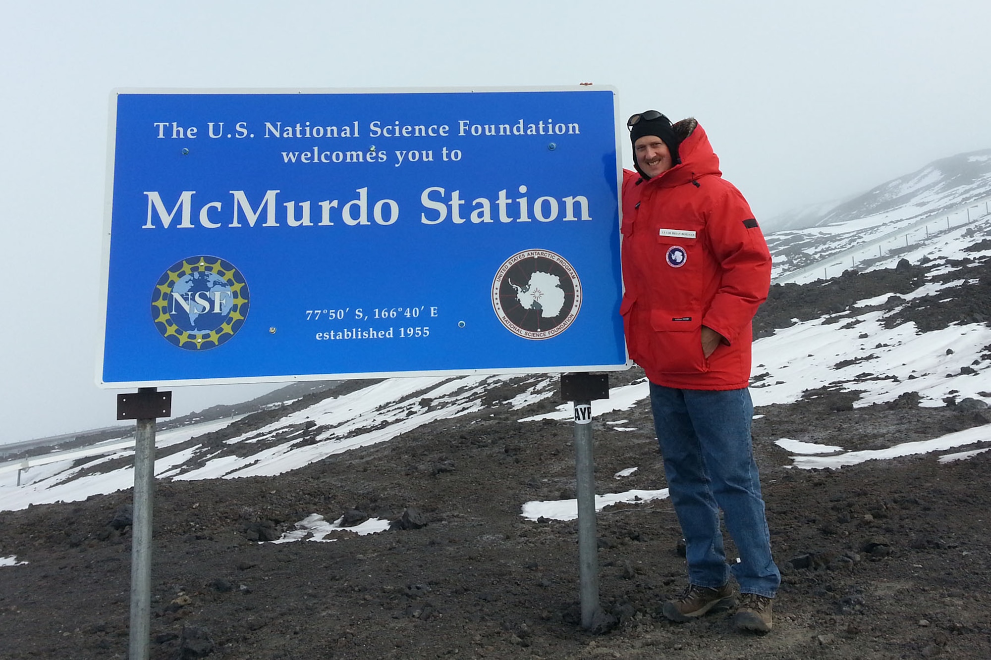 U.S. Air Force Lt. Col. Brian Bohlman, chaplain assigned to the 169th Fighter Wing, poses in front of the McMurdo Station sign in Antarctica, Oct. 22, 2016. (Courtesy photo of the National Science Foundation)