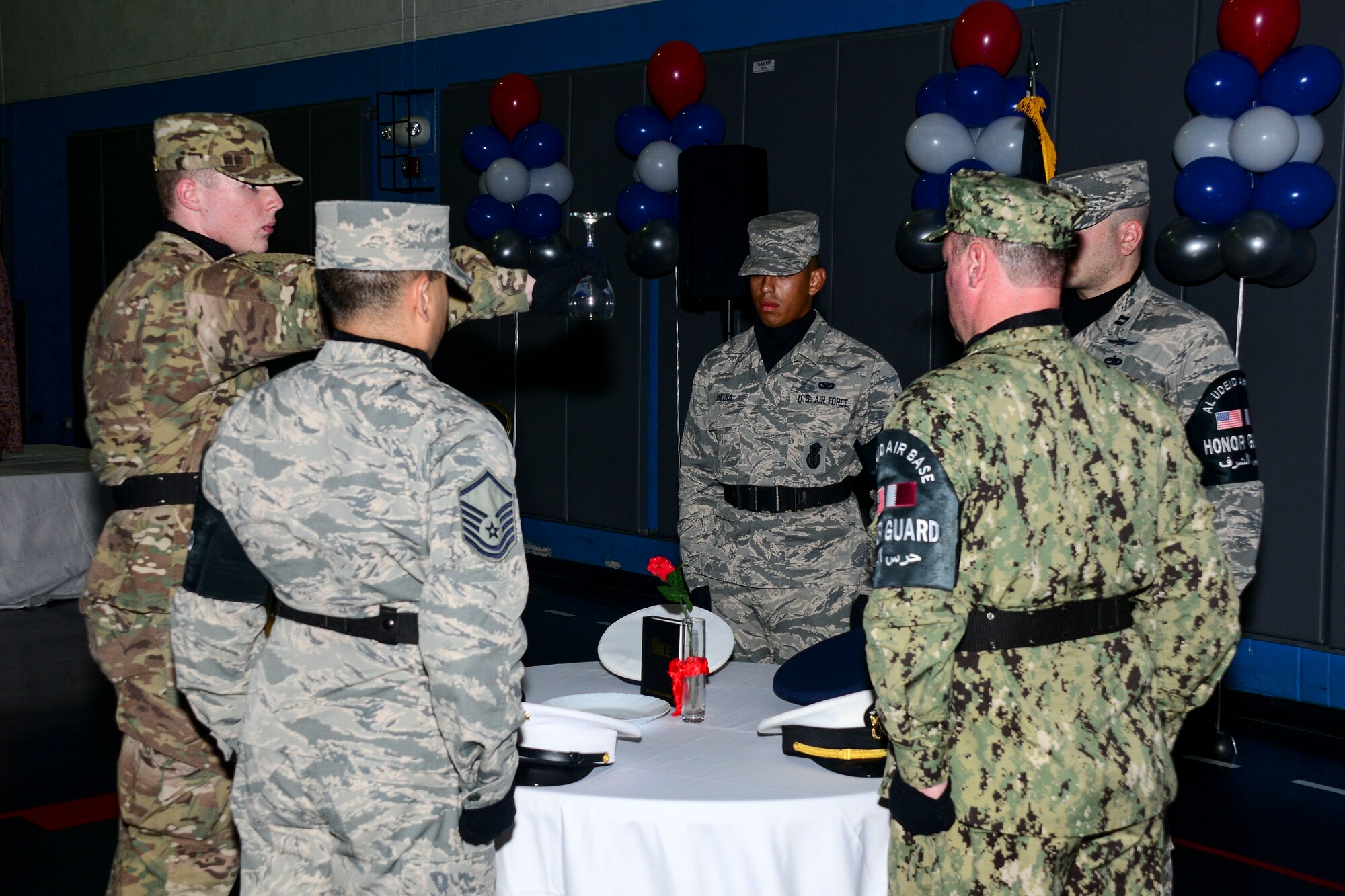 Members of the 379th Air Expeditionary Wing honor guard perform a Prisoner of War and Missing in Action tribute during the base’s inaugural Air Force Ball Sept. 23, 2016, at Al Udeid Air Base, Qatar. The ball is an Air Force-wide tradition to celebrate the heritage and history of the Air Force. (U.S. Air Force photo/Staff Sgt. Jayson Santoyo/Released)