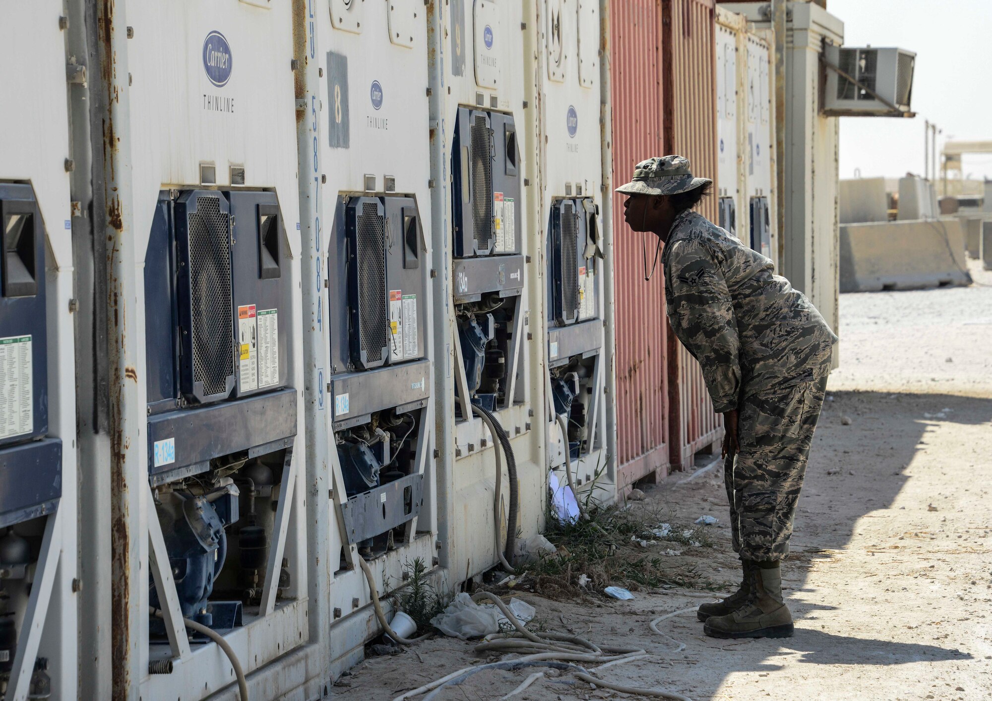 Airman 1st Class Shanette Whitehead, 379th Expeditionary Force Support Squadron service journeyman, checks the temperature of the facility’s external refrigerators and freezers Sept. 20, 2016, at Al Udeid Air Base, Qatar. Temperature checks of the external storage units are conducted every hour to ensure the food is being stored at the proper temperature. (U.S. Air Force photo/Senior Airman Janelle Patiño/Released)