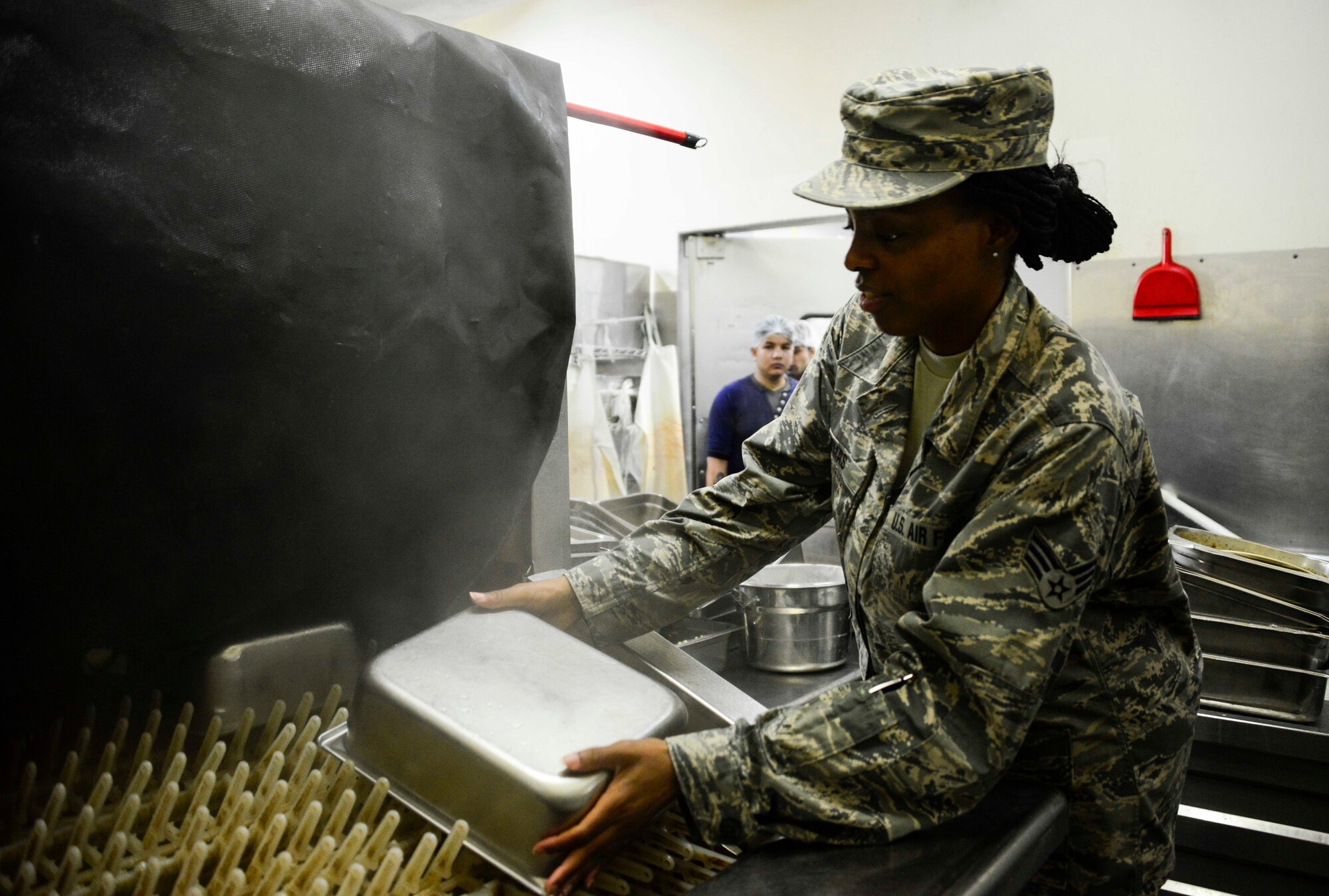 Senior Airman Monae Thomas, 379th Expeditionary Force Support Squadron service journeyman, puts a pan through the pot wash to test the temperature of the water as part of the unit’s weekly internal public health inspection at the Independence Dining Facility Sept. 20, 2016, at Al Udeid Air Base, Qatar. There are three main dining facilities here: the Independence, Manhattan and the Blatchford-Preston DFACs. Service journeymen in the Independence DFAC provide quality meals to about 5,000 members in a 24-hour period. (U.S. Air Force photo/Senior Airman Janelle Patiño/Released) 