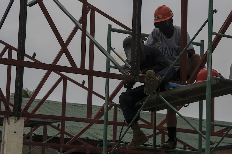 A U.S. Marine engineer with Bravo Company, 9th Engineer Support Battalion, 3d Marine Logistics Group, III Marine Expeditionary Force, welds alongside a Philippine Navy builder in order to build a good support system while restoring a section of the San Vincente Elementary School during the engineering civic assistance project in support of Philippine Amphibious Landing Exercise 33 (PHIBLEX) in Cagayan, Philippines, Sept. 27, 2016. PHIBLEX 33 is an annual U.S.-Philippine military bilateral exercise that combines amphibious landing and live-fire training with humanitarian civic assistance efforts to strengthen interoperability and working relationships. (U.S. Marine Corps photo by MCIPAC Combat Camera Cpl. Allison Lotz/Released)