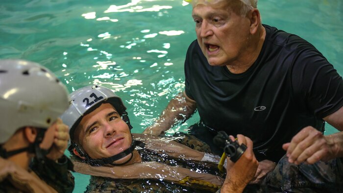 Sgt. Gregory Stewart looks on as a fellow Marine learns proper underwater breathing techniques during a training exercise at Marine Corps Base Camp Lejeune, N.C., Sept. 26, 2016. The Modular Amphibious Egress Training, also known as the Helo Dunker, teaches Marines survival techniques to use if a helicopter lands in the water. Stewart is a crewman with 2nd Light Armored Reconnaissance Battalion. 