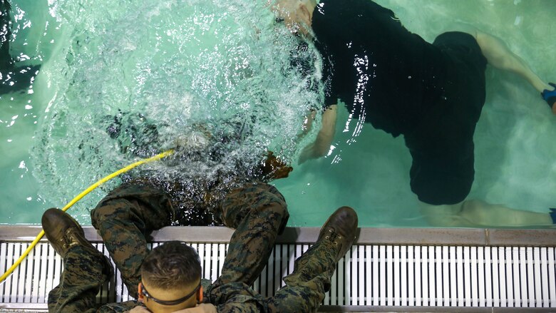 A Marine is submerged underwater practicing underwater breathing techniques during a training exercise at Marine Corps Base Camp Lejeune, N.C., Sept. 26, 2016. The Modular Amphibious Egress Training, also known as the Helo Dunker, teaches Marines survival techniques to use if a helicopter lands in the water. The Marines conducting the training are with 2nd Light Armored Reconnaissance Battalion. 