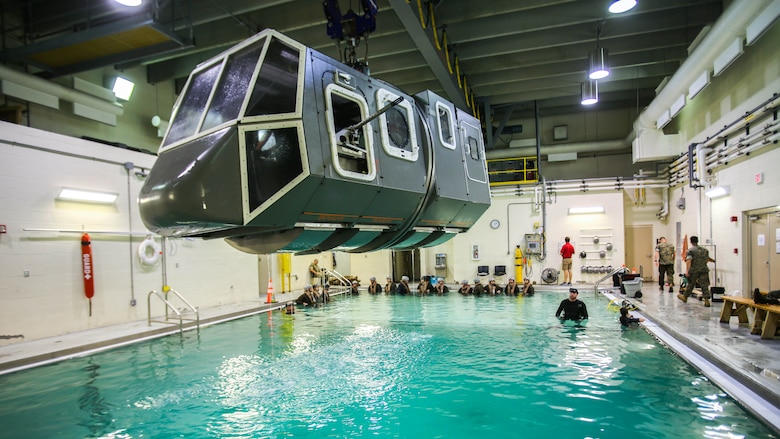 Marines prepare to be dunked in a simulated helicopter crash during a training exercise at Marine Corps Base Camp Lejeune, N.C., Sept. 26, 2016. The Modular Amphibious Egress Training, also known as the Helo Dunker, teaches Marines survival techniques to use if a helicopter lands in the water. The Marines conducting the training are with 2nd Light Armored Reconnaissance Battalion. 