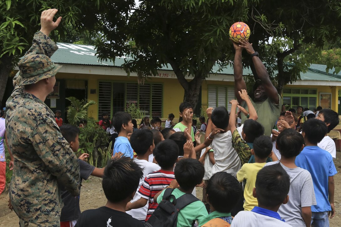 U.S. Marine engineers with Bravo Company, 9th Engineer Support Battalion, 3d Marine Logistics Group, III Marine Expeditionary Force, play games with local Filipino children while participating in the engineering civic assistance project during Philippine Amphibious Landing Exercise 33 (PHIBLEX), here, Sept. 27, 2016. PHIBLEX 33 is an annual U.S.-Philippine military bilateral exercise that combines amphibious capabilities and live-fire training with humanitarian civic assistance efforts to strengthen interoperability and working relationships. (U.S. Marine Corps photo by MCIPAC Combat Camera Cpl. Allison Lotz/Released)