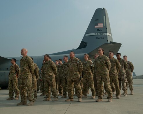 Airmen from the 774th Expeditionary Airlift Squadron and the 455th Expeditionary Aeromedical Evacuation Squadron gather in a formation during the TORQE 62 remembrance ceremony, Bagram Airfield, Afghanistan, Oct. 2, 2016. Six Airmen were lost on Oct. 2, 2015 when TORQE 62, a C-130J Super Hercules, crashed during takeoff. (U.S. Air Force photo by Capt. Korey Fratini)
