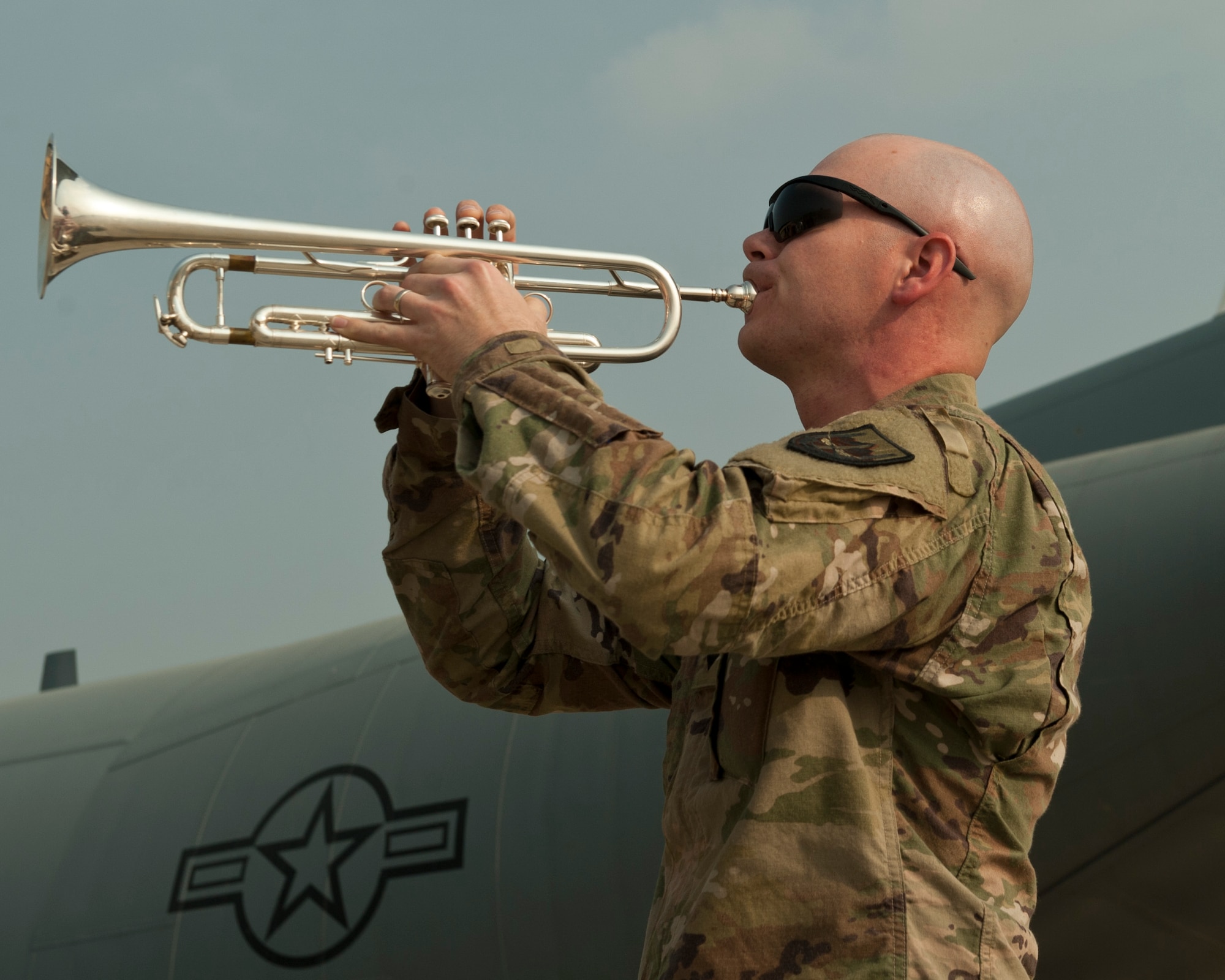 A bugle player with the U.S. Forces Afghanistan Band plays taps during the TORQE 62 remembrance ceremony, Bagram Airfield, Afghanistan, Oct. 2, 2016. The ceremony was held to honor and remember those lost when TORQE 62 crashed on Oct. 2, 2015. (U.S. Air Force photo by Capt. Korey Fratini)