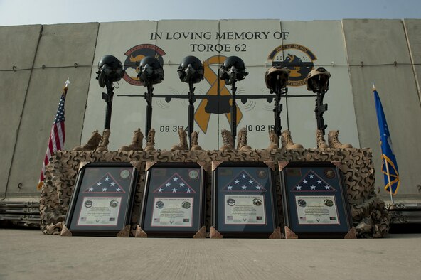 Battlefield crosses representing the six Airmen lost during a C-130J crash, are placed in front of a mural in memory of TORQE 62, Bagram Airfield, Afghanistan, Oct. 2, 2016. A ceremony was held to remember and honor the live lost when TORQE 62 crash during takeoff at Jalalabad Airfield, Afghanistan, Oct. 2, 2015. (U.S. Air Force photo by Capt. Korey Fratini)