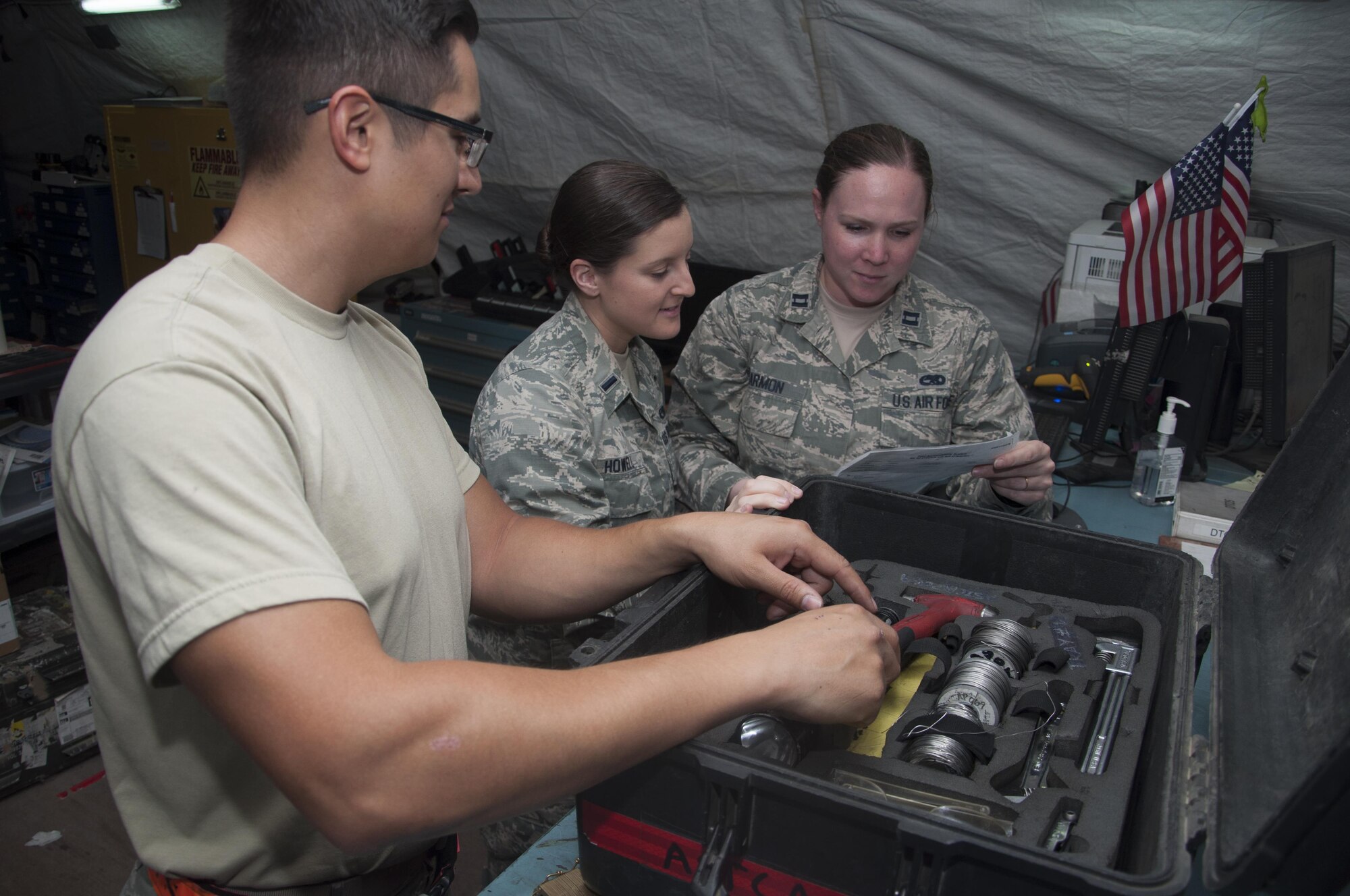 Staff Sgt. Bradley Chaplin, 1st Lt. Erin Howell and Capt. Katherine Harmon from the 5th Expeditionary Air Mobility Squadron inspect a tool kit that is used for maintenance Sept. 29, 2016 at an undisclosed location in Southwest Asia. They support the maintainers by ensuring that equipment and parts are available to get the mission accomplished.(U.S. Air Force photo by Master Sgt. Anika Jones/Released)