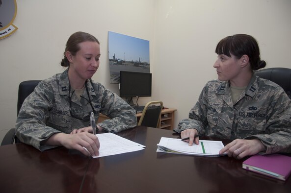 Capt. Grace Miller from the 386th Expeditionary Aircraft Maintenance Squadron and Capt. Shelly Martin from the 386th Expeditionary Maintenance Squadron discuss the plans resolve issues Sept. 27, 2016 at an undisclosed location in Southwest Asia. They ensure the unit operations run smoothly and that they have the resources needed to accomplish the mission. (U.S. Air Force photo by Master Sgt. Anika Jones/Released)